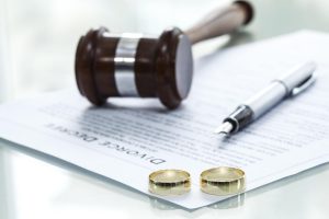 divorce document and wedding rings